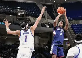  ?? Charles Rex Arbogast/Associated Press ?? UConn’s Tristen Newton (2) shoots over DePaul’s Javan Johnson during the first half on Tuesday in Chicago.