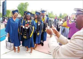  ?? CHRIS BARBER — DIGITAL FIRST MEDIA ?? The cameras were clicking as relatives photograph­ed students processing to graduation.