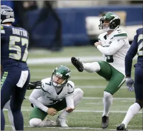  ?? LINDSEY WASSON — THE ASSOCIATED PRESS ?? Jets kicker Sergio Castillo, second from right, kicks a field goal as Braden Mann (7) holds during Sunday’s game against the Seahawks in Seattle.