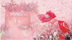  ?? REUTERS ?? Liverpool players on an open-top bus and fans celebrate winning the FA Cup and League Cup during a victory parade in the English city last month.