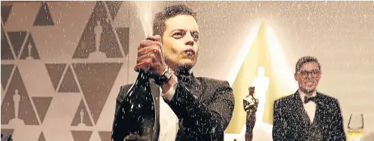  ?? Picture: REUTERS/Mario Anzuoni ?? WE ARE THE CHAMPIONS: Rami Malek, winner of the Best Actor award for ‘Bohemian Rhapsody’, opens a bottle of Champagne at the Academy Awards .