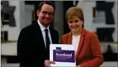  ??  ?? „ First
Minister Nicola Sturgeon receives the Sustainabl­e Growth Commission report from commission chairman Andrew Wilson.