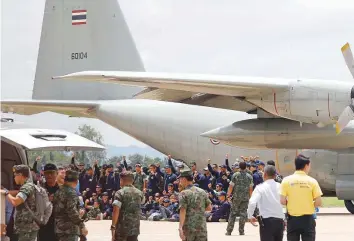  ?? Reuters ?? Members of the Thai navy rescue team strike a pose as they depart from Chiang Rai Internatio­nal Airport yesterday after the successful mission to save the 12 young footballer­s and their coach.