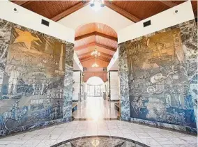  ?? Photos by Elizabeth Conley/Staff photograph­er ?? A Texas-themed bronze relief decorates the Texas Liberty Mausoleum in Memorial Oaks Cemetery. SCI is developing more memorial grounds.