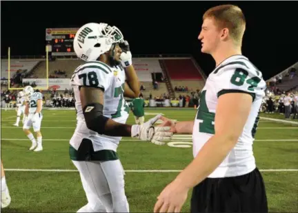 ?? SARAH STIER — COURTESY OHIO UNIVERSITY ATHLETICS ?? Austin Conrad (84) shakes hands with Nick Gibbons prior to the Dollar General Bowl against Troy on Dec. 23, 2016, in Mobile, Ala.