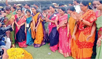  ??  ?? TRS MP K. Kavitha dances along with other women during Bathukamma celebratio­ns at the LB Stadium on Tuesday. — P. ANIL