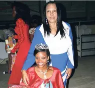  ??  ?? Dr Ellonia Rochester Grant (standing), the 1969 National Farm Queen, congratula­tes Peta-Gay Stewart, Miss St Mary, the 2015 National Farm Queen, following her coronation.