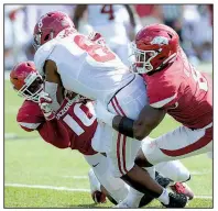  ?? NWA Democrat-Gazette/ANDY SHUPE ?? Arkansas defenders Randy Ramsey (left) and De’Jon Harris tackle Alabama’s Josh Jacobs on Oct. 6. In the past three games, the Razorbacks have faced three of the top offenses in the nation.