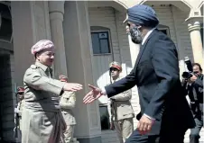  ?? SAFIN HAMED/AFP/GETTY IMAGES ?? Iraqi Kurdish leader Massud Barzani, left, welcomes Defence Minister Harjit Sajjan last July in in Arbil, the capital of the Kurdish autonomous region in Northern Iraq.