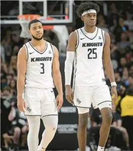  ?? EBENHACK/AP PHELAN M. ?? UCF forward Taylor Hendricks (25) and guard Darius Johnson (3) likely will have to put on strong showings vs. Temple if the Knights want to return home with a win.