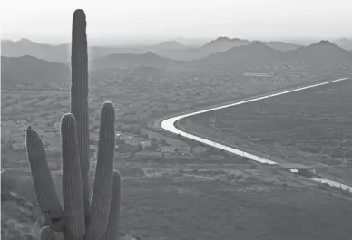  ?? DAVID WALLACE/THE REPUBLIC ?? The CAP Canal winds through a neighborho­od on one side and the desert on the other in Phoenix.