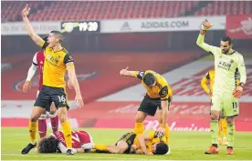  ?? Photo / AP ?? Players signal for help after the head clash between Jiminez and Luiz.