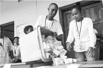  ??  ?? An election official empties a ballot box during the counting process of the presidenti­al elections in Dili. — Reuters photo