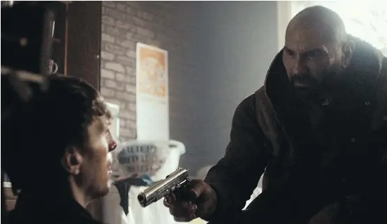  ?? RLJ ENTERTAINM­ENT ?? Alex Breaux, left, and Dave Bautista share a tense moment in the cautionary new movie, Bushwick.