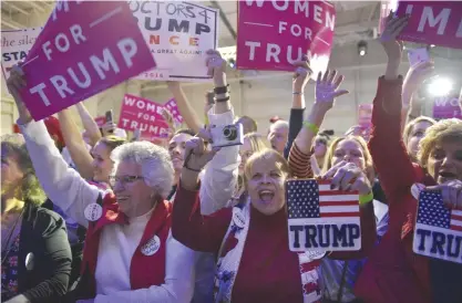  ?? — AFP ?? PENNSYLVAN­IA: Campaign of Republican presidenti­al nominee Donald Trump Supporters cheer as the plane carrying Republican presidenti­al nominee Donald Trump arrives for a campaign rally at Atlantic Aviation in Moon Township.