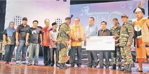  ??  ?? Len Talif (sixth right) hands over the championsh­ip trophy to a representa­tive of Kumpulan Bayu, while Salehudin (fifth right) and Hazami (fourth right) look on.