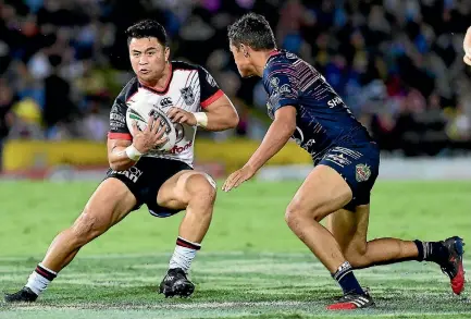  ?? PHOTO: PHOTOSPORT ?? Warriors halfback Mason Lino takes on the Cowboys defence in the NRL match in Townsville on Saturday night.