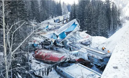  ?? JEFF MCINTOSH / THE CANADIAN PRESS ?? Crumpled train cars lie near Field, B.C., after Monday’s deadly derailment.