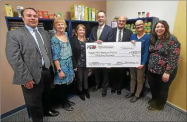  ?? PETE BANNAN – DIGITAL FIRST MEDIA ?? West Chester University’s Resource Pantry for students in need received a $45,000 check from the not-for-profit Student Services Incorporat­ed and the credit union PSECU on Tuesday. Taking part in the presentati­on are, from left, Matt Holliday,...