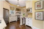  ??  ?? The country-style kitchen includes ceramic tile backsplash and built-in stainless appliances.