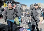  ?? HADI MIZBAN THE ASSOCIATED PRESS ?? People and security forces gather at the site of a deadly bomb attack in Baghdad, Iraq, Thursday.