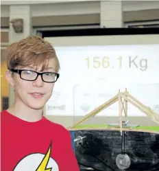  ?? ALLAN BENNER/POSTMEDIA NETWORK ?? Wyatt Lee, 12, created a bridge that can support more than 156 kg out of Popsicle sticks, to win the Profession­al Engineers of Ontario Niagara chapter Bridge Buster competitio­n held at the St. Catharines YMCA on Saturday.