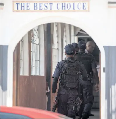  ??  ?? Policemen walk inside the Tranquilli­ty Funeral Home.