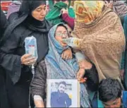  ?? PTI ?? The mother of missing Noida university student holds his picture during a protest in Srinagar on Thursday.