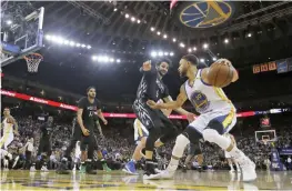  ?? —AP ?? OAKLAND: Golden State Warriors guard Stephen Curry (30) dribbles next to Minnesota Timberwolv­es guard Ricky Rubio (9) during the second half of an NBA basketball game Tuesday, in Oakland, Calif. The Warriors won 121-107.