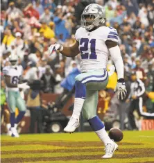  ?? Patrick Smith / Getty Images ?? Dallas’ Ezekiel Elliott scores on a 13-yard run for the first of his two touchdowns against Washington.