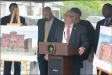  ?? JOHN BERRY — THE TRENTONIAN ?? Mayor Reed Gusciora, center, and several city council members held a press conference Friday to discuss plans for redevelopm­ent of the former Cook School building.