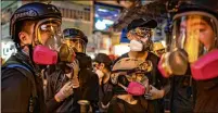  ?? ANTHONY KWAN / GETTY IMAGES ?? Protesters gather outside a police station Saturday during a standoff in the Mongkok district in Hong Kong. Pro-democracy protesters have continued rallies in the streets against a controvers­ial extraditio­n bill.