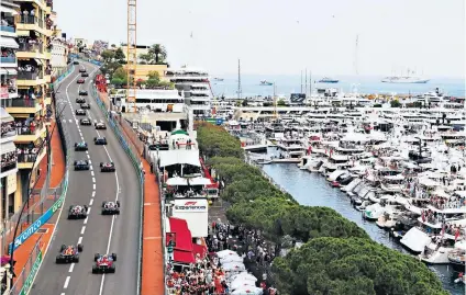  ?? ?? Upwardly mobile: Cars climb on the opening lap of Sunday’s Monaco GP