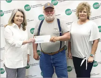  ?? Brodie Johnson • Times-Herald ?? The Woodruff Electric Cooperativ­e recently awarded donations to the Forrest City School District and Le Bonheur Children’s Hospital. Danielle Deere, left, with Woodruff, presents a donation to Steve Roberts as Lisa Long, also with Woodruff, looks on.