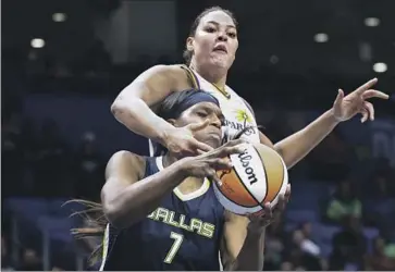  ?? Shafkat Anowar Associated Press ?? LIZ CAMBAGE, defending against Dallas Center Teaira McCowan on July 1, appeared to be rounding into form by scoring in double figures in five of six games. But she had to miss two games because of virus protocols.