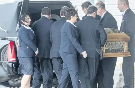  ?? BOB TYMCZYSZYN/POSTMEDIA NETWORK ?? The casket of 7-year-old Nathan Dumas is loaded into a hearse after the funeral Friday at Pleasantvi­ew Funeral Home in Thorold.