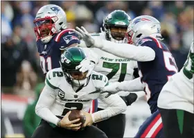  ?? MICHAEL DWYER/THE ASSOCIATED PRESS ?? New York Jets quarterbac­k Zach Wilson is sacked by New England Patriots defensive end Deatrich Wise Jr., left, and linebacker Josh Uche during the second half of Sunday’s game in Foxborough, Mass.