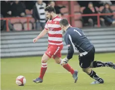  ??  ?? Ryan Blott rounds the Mossley keeper, but fires wide of the target