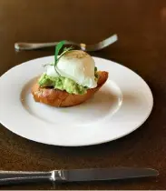  ??  ?? A barge breakfast of poached egg on avocado toast.