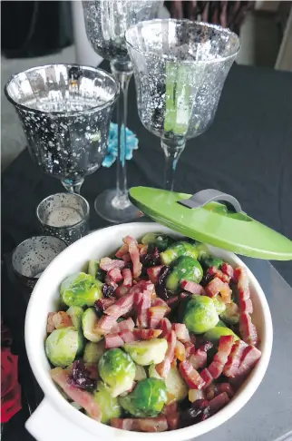  ??  ?? Christophe­r Chafe created this side dish of Brussels sprouts, which he tops off with bacon and dried cranberrie­s.