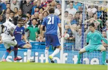  ?? THE ASSOCIATED PRESS ?? Crystal Palace’s Bacary Sako, left, scores his side’s first goal at Chelsea on Saturday.