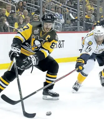  ?? KIRK IRWIN/GETTY IMAGES ?? Sidney Crosby of the Pittsburgh Penguins controls the puck against Mattias Ekholm of the Nashville Predators in the second period in Game Five of the 2017 NHL Stanley Cup Final at PPG PAINTS Arena, on Thursday, in Pittsburgh, Penn.