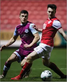  ??  ?? Drogheda’s James Brown keeps tabs on Jason McClelland.