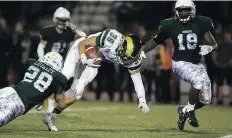  ?? KAYLE NEIS ?? University of Regina Rams running back Atlee Simon is hauled down during the game against the University of Saskatchew­an Huskies on Friday night at Griffiths Stadium. The Huskies lost 50-40.