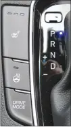  ??  ?? Controls for the heated seats and steering wheel are situated next to the gear shift along with a button to select three different drive modes, which change the car’s dynamics.