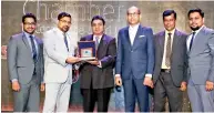  ??  ?? Lalith Lokuge, Chairman - Thunder & Neon Group, receiving the award from Sujeeva Samaraweer­a, President - National Chamber of Commerce of Sri Lanka.