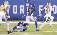  ?? Bill Kostroun/Associated Press ?? ■ New Orleans Saints’ Alvin Kamara, right, runs for a touchdown during the second half against the New York Giants on Sunday in East Rutherford, N.J. Kamara ran for three second-half touchdowns in the Saints’ 33-18 victory over the Giants.