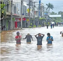  ?? Waisea Nasokia ?? People in Nadi Town during the recent flood.Photo: