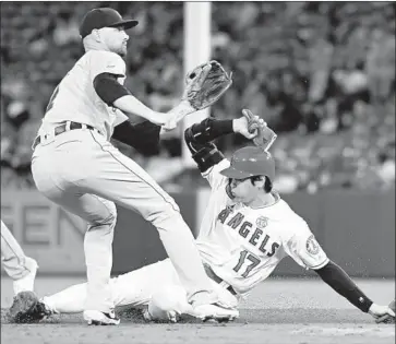  ?? John McCoy Getty Images ?? SHOHEI OHTANI EASILY steals second base in the third inning, his ninth stolen base of the season.