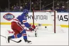  ?? Bebeto Matthews / Associated Press ?? The Rangers’ Alexis Lafrenière (13) scores past Red Wings goaltender Thomas Greiss on Saturday.